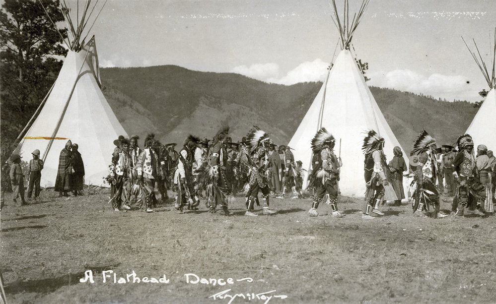 Native Americans in front of teepee